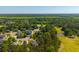 Scenic aerial view of a community bordering a golf course with mature trees at 105 Birkbeck Ct, Goose Creek, SC 29445