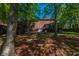 Expansive backyard featuring a brick home, screened porch, hot tub, and mature trees at 105 Birkbeck Ct, Goose Creek, SC 29445
