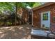 Brick backyard patio with chair and table next to a red brick home at 105 Birkbeck Ct, Goose Creek, SC 29445