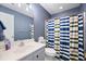 Bathroom with a white vanity, a blue and green shower curtain, and blue-gray walls at 105 Birkbeck Ct, Goose Creek, SC 29445