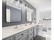 Bathroom with a double sink vanity, large mirrors, gray walls, and a soaking tub next to a window at 105 Birkbeck Ct, Goose Creek, SC 29445