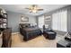 Bedroom with gray walls, carpet flooring, a ceiling fan, and a comfortable bed with dark bedding at 105 Birkbeck Ct, Goose Creek, SC 29445