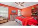 Cozy bedroom with an orange wall, a ceiling fan, and a red bed with matching bedding at 105 Birkbeck Ct, Goose Creek, SC 29445