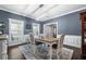 Dining room with blue walls, decorative rug, stylish lighting, and windows that allow plenty of natural light at 105 Birkbeck Ct, Goose Creek, SC 29445