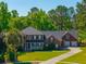 Charming two-story brick home with a welcoming front porch and well-manicured lawn at 105 Birkbeck Ct, Goose Creek, SC 29445
