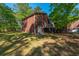 Rear view of a brick home featuring a walkout basement door and a small wooden deck at 105 Birkbeck Ct, Goose Creek, SC 29445