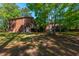 Rear view of a brick home featuring a walkout basement door and a small wooden deck at 105 Birkbeck Ct, Goose Creek, SC 29445