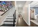 Hallway with hardwood floors, staircase with Gathering photos, and doorways leading to various rooms at 105 Birkbeck Ct, Goose Creek, SC 29445