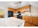 Kitchen with wooden cabinets, black appliances, hardwood floors, and a farmhouse style table at 105 Birkbeck Ct, Goose Creek, SC 29445
