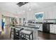 Spacious kitchen island with barstool seating, white cabinetry, and dark countertops, perfect for casual dining and entertaining at 105 Birkbeck Ct, Goose Creek, SC 29445