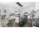 Bright kitchen featuring white cabinets, dark countertops, stainless steel appliances, and an island with barstool seating at 105 Birkbeck Ct, Goose Creek, SC 29445