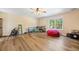 Spacious living room with light wood flooring, a window, and a ceiling fan at 105 Birkbeck Ct, Goose Creek, SC 29445
