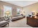 Home office with neutral walls, two windows with blinds, a gray couch, and a large wooden desk at 105 Birkbeck Ct, Goose Creek, SC 29445