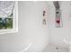 Shower stall featuring white tile, recessed shelves, a rainfall showerhead, and a patterned tile floor at 105 Birkbeck Ct, Goose Creek, SC 29445