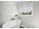 Bright bathroom with white subway tile, a freestanding tub, a window, and stylish fixtures at 105 Birkbeck Ct, Goose Creek, SC 29445