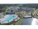 Beautiful aerial view of community amenities including pool, clubhouse, amphitheater, and lake at 108 Bluff Isle Ct, Summerville, SC 29486