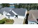 Aerial view of a beautiful home featuring a well-kept lawn and access to a serene lake at 108 Bluff Isle Ct, Summerville, SC 29486