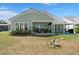 Beautiful backyard with patio, garden, outdoor seating, and well-maintained lawn at 108 Bluff Isle Ct, Summerville, SC 29486