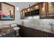 Elegant bar area with granite countertops, mosaic backsplash, wine rack and custom cabinets at 108 Bluff Isle Ct, Summerville, SC 29486
