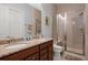 Bathroom featuring double vanity, framed mirror, and tiled walk-in shower at 108 Bluff Isle Ct, Summerville, SC 29486