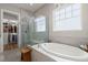 Modern bathroom with soaking tub and walk-in shower with glass enclosure at 108 Bluff Isle Ct, Summerville, SC 29486