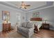 Bedroom with wood floors, large bed, sitting area, and ensuite bathroom at 108 Bluff Isle Ct, Summerville, SC 29486