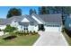 Charming home with a well-manicured lawn, inviting curb appeal, and a two-car garage at 108 Bluff Isle Ct, Summerville, SC 29486