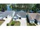 Aerial view of charming blue home with a well-manicured lawn and stunning water views at 108 Bluff Isle Ct, Summerville, SC 29486