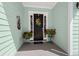 Inviting front porch features beautiful decor and potted red geraniums at 108 Bluff Isle Ct, Summerville, SC 29486