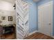 Hallway with herringbone sliding door, closet and blue walls at 108 Bluff Isle Ct, Summerville, SC 29486