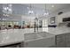 A kitchen island features double sinks and a view of the dining and living areas at 108 Bluff Isle Ct, Summerville, SC 29486