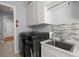 Laundry room with gray cabinetry, stylish tile backsplash, and washer/dryer at 108 Bluff Isle Ct, Summerville, SC 29486