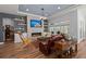 Living room with a fireplace, a large television, and hardwood floors, perfect for relaxation and entertainment at 108 Bluff Isle Ct, Summerville, SC 29486