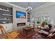 Cozy living room with a fireplace, built-in shelving, and views of the lake at 108 Bluff Isle Ct, Summerville, SC 29486