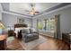 Bright main bedroom with a ceiling fan, hardwood floors, and abundant natural light at 108 Bluff Isle Ct, Summerville, SC 29486