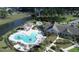 Aerial view of a community pool featuring palm trees, lounge chairs and a covered patio with tables and chairs at 108 Bluff Isle Ct, Summerville, SC 29486