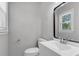 Well-lit half-bath featuring a modern vanity, new paint, and a window that provides natural light at 108 Wadmalaw Cir, Summerville, SC 29483