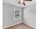 Bedroom with wood-look flooring, ceiling fan, and a window at 108 Wadmalaw Cir, Summerville, SC 29483