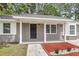 Welcoming front porch with painted brick columns and trim, offering a cozy and shaded entrance to the home at 108 Wadmalaw Cir, Summerville, SC 29483