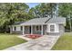 Inviting home showcasing neat landscaping, gray brick, and white trim, creating a welcoming and well-maintained exterior at 108 Wadmalaw Cir, Summerville, SC 29483