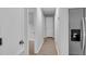 Bright hallway features laminate floors, modern paint colors, and stainless refrigerator at 108 Wadmalaw Cir, Summerville, SC 29483