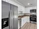 Kitchen boasts stainless steel appliances, white cabinets, and wood-look flooring at 108 Wadmalaw Cir, Summerville, SC 29483