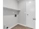Laundry room featuring white shelving and wood-look flooring at 108 Wadmalaw Cir, Summerville, SC 29483