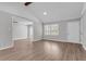Spacious living room with wood floors, offering ample natural light from the windows and a seamless flow into adjacent spaces at 108 Wadmalaw Cir, Summerville, SC 29483