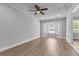 Living room boasts wood-look flooring, bay window, and a ceiling fan at 108 Wadmalaw Cir, Summerville, SC 29483