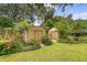 The home's backyard has mature landscaping, lush lawns, and two storage sheds at 110 Jackson Rd, Ladson, SC 29456