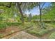 Beautiful backyard garden with stone pathways, mature trees and unique landscaping at 110 Jackson Rd, Ladson, SC 29456