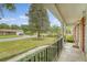 Charming front porch view with a view of the lush front yard and tree-lined street beyond at 110 Jackson Rd, Ladson, SC 29456