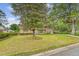 Inviting brick home with a well-kept lawn, mature trees, and a welcoming front entrance at 110 Jackson Rd, Ladson, SC 29456