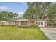 Attractive brick home with shutters, complemented by a lush green lawn and mature landscaping at 110 Jackson Rd, Ladson, SC 29456